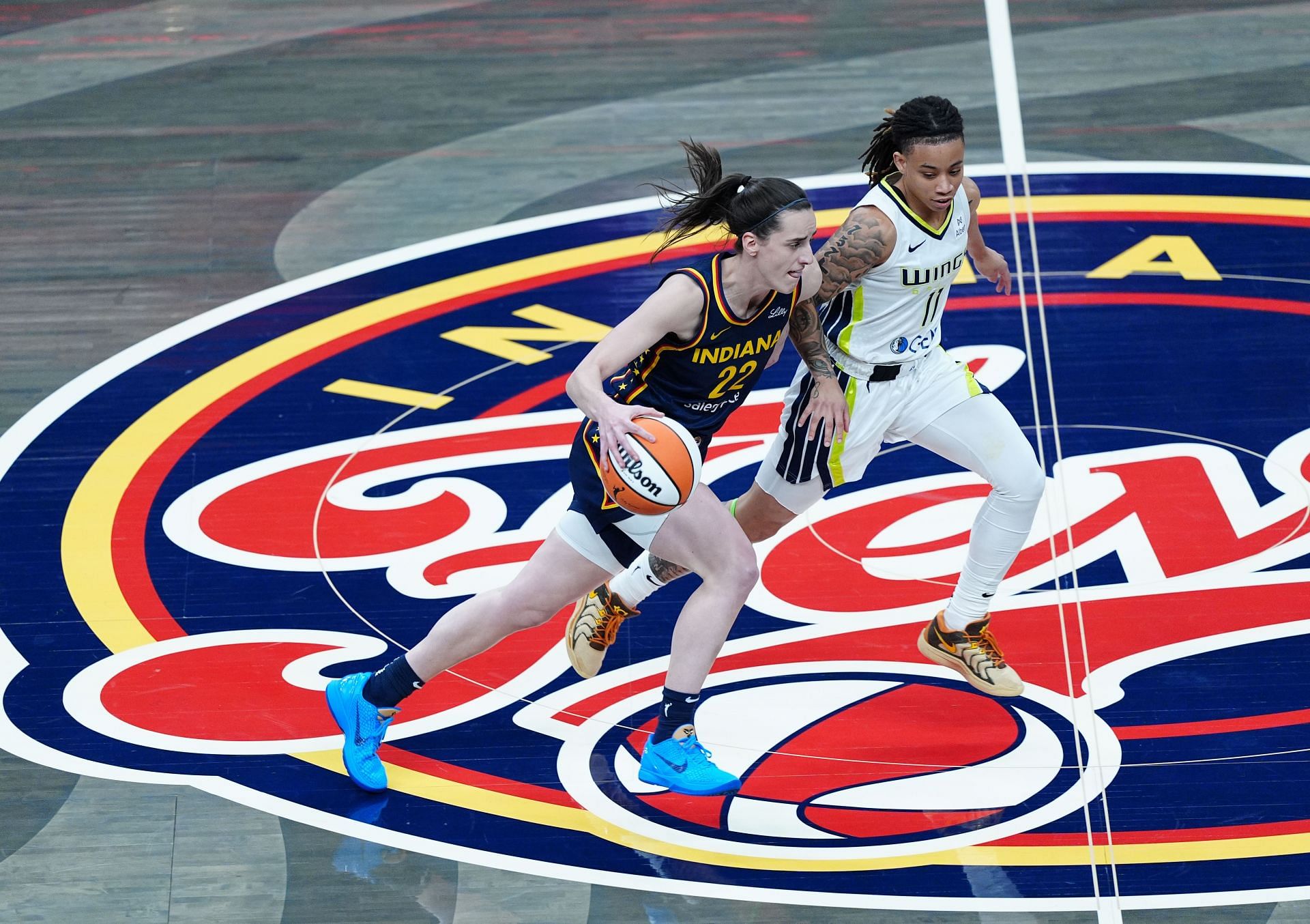 Indiana Fever Caitlin Clark (22) brings the ball up court against Dallas Wings guard JJ Quinerly (11) on July 13, 2025, at Gainbridge Fieldhouse in Indianapolis, Indiana. (Photo by Brian Spurlock/Icon Sportswire via Getty Images)